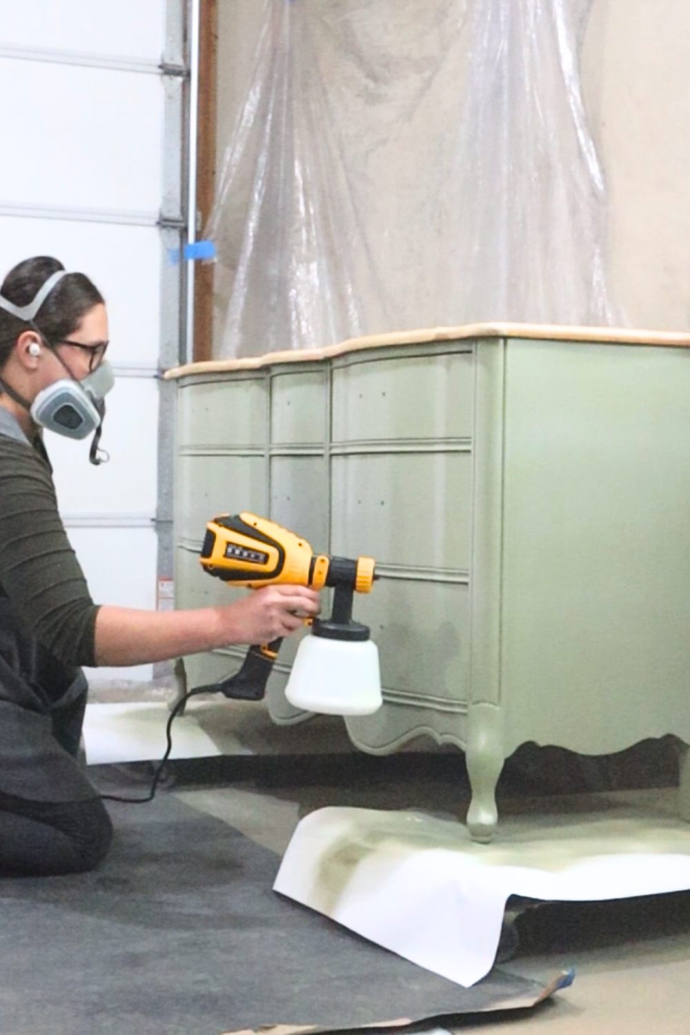 spraying paint onto closed drawers