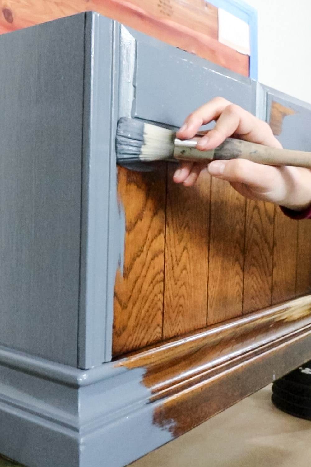 brushing paint onto cedar chest