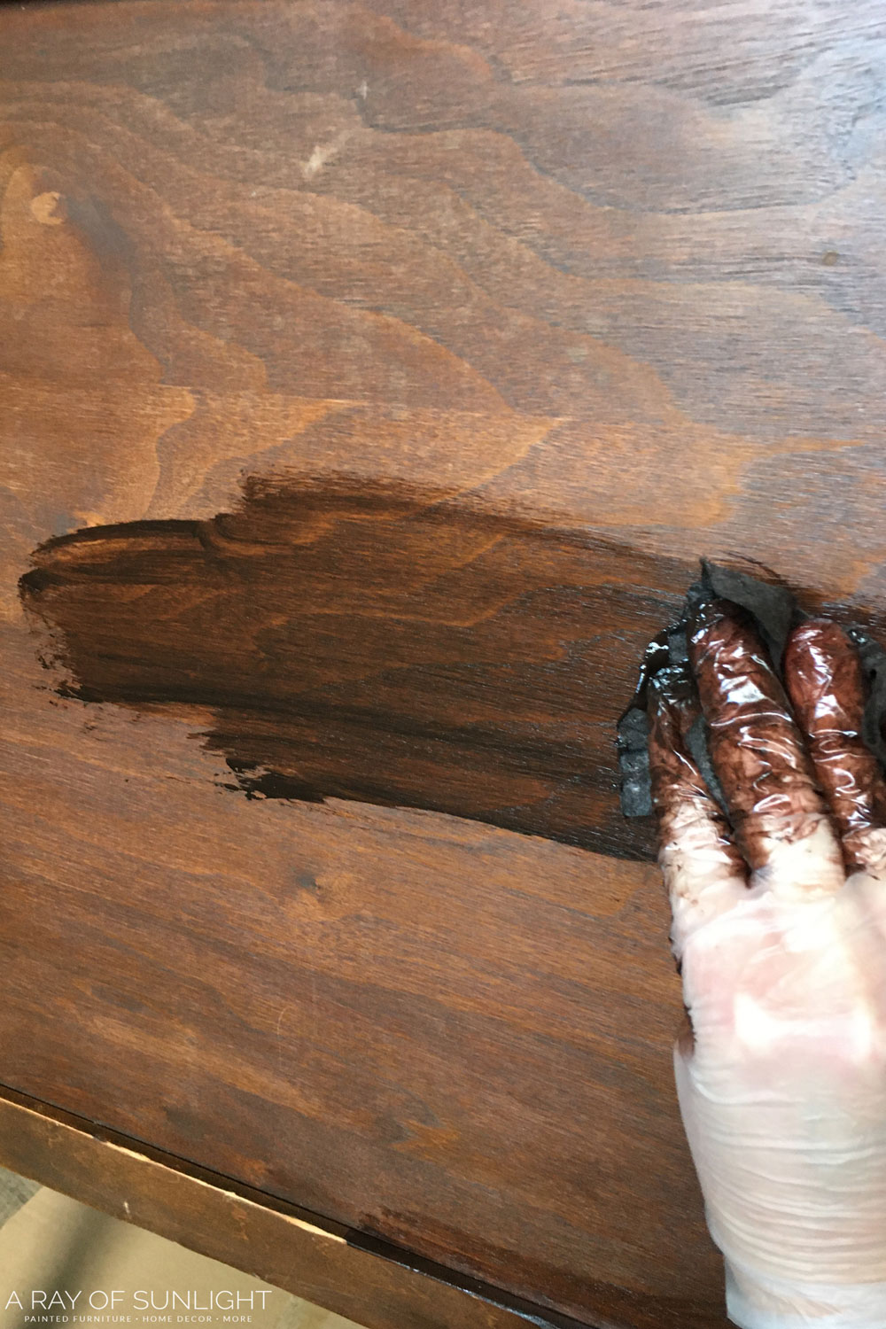 closeup of applying stain with a rag